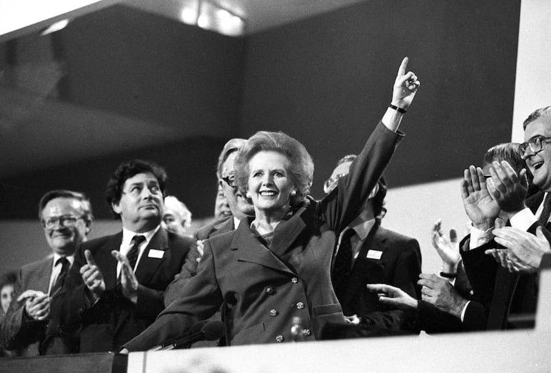 British Prime Minister Margaret Thatcher points skyward as she receives a standing ovation at the Conservative Party Conference on October 13, 1989.