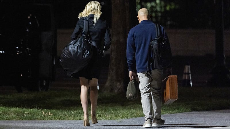 Donald Trump's aide Natalie Harp and White House Director of Oval Office Operations Walt Nauta walk back to the White House after landing by helicopter from Camp David.