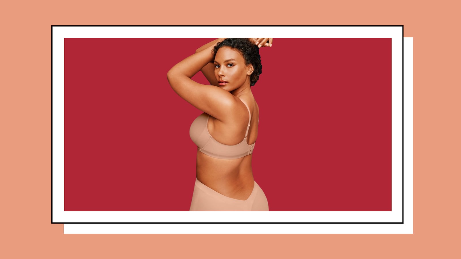 Woman wearing nude colored shapewear on a solid red background.