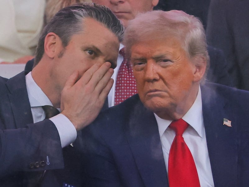 U.S. Secretary of Defense Pete Hegseth talks to U.S. President Donald Trump during the U.S. Army's 250th Birthday parade, on the same day of U.S. President Donald Trump 79th birthday, in Washington, D.C., U.S., June 14, 2025. REUTERS/Carlos Barria     TPX IMAGES OF THE DAY