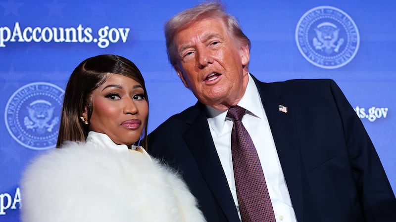 WASHINGTON, DC - JANUARY 28: Musician Nicki Minaj (L) joins U.S. President Donald Trump on stage as he delivers remarks during the Treasury Department's Trump Accounts Summit at Andrew W. Mellon Auditorium on January 28, 2026 in Washington, DC. "Trump Accounts" are a portion of recently passed tax and spending legislation where the federal government will deposit $1,000 into investment accounts for every child born between 2025 and 2028 once parents sign their children up while filing their income taxes.  (Photo by Win McNamee/Getty Images)