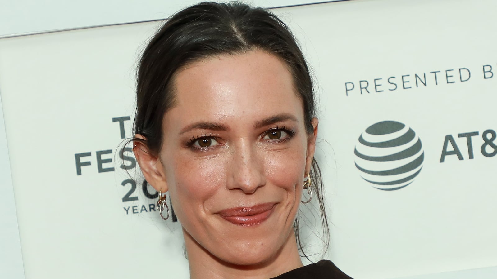 Rebecca Hall smiles tight-lipped.