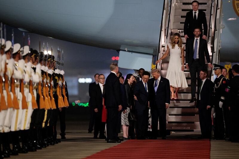 U.S. President Donald Trump, Elon Musk, Eric Trump and his wife Lara, participate in an arrival ceremony at Beijing Capital International Airport, in Beijing, China, May 13, 2026. REUTERS/Evan Vucci