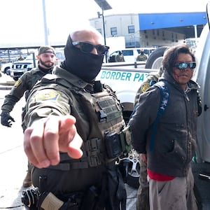 A person is detained by US Customs and Border Patrol (CBP) agents near a Lowe's hardware store in New Orleans, Louisiana