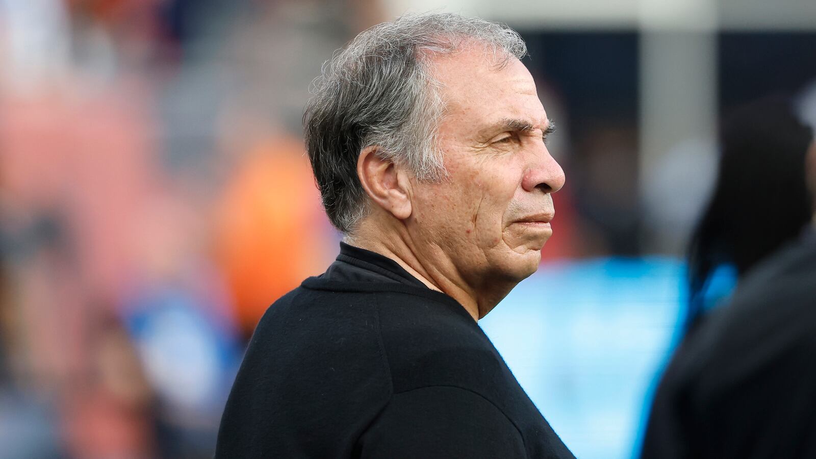 Bruce Arena stares forward on the sideline of an MLS match.