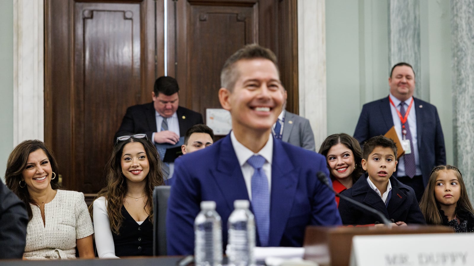 WASHINGTON, DC - JANUARY 15: The family of Sean Duffy, U.S. President-elect Donald Trump's nominee for Secretary of Transportation, sits behind him as he testifies before the Senate Commerce, Science, and Transportation Committee during his confirmation hearing in the Russell Senate Office Building on January 15, 2025 in Washington, DC. Duffy, who served three terms as a Republican Representative for Wisconsin, has bipartisan support in the Senate. (Photo by Samuel Corum/Getty Images)