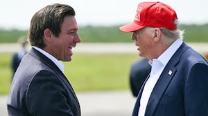 Florida Governor Ron DeSantis shakes hands with US President Donald Trump upon Trump's arrival at Dade-Collier Training and Transition Airport in Ochopee, Florida, on July 1, 2025.