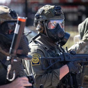 Federal law enforcement agents are confronted by community members and activists for reportedly shooting a woman in the Brighton Park neighborhood on October 04, 2025 in Broadview, Illinois. Residents of the city have become increasingly concerned as Operation Midway Blitz continues in the Chicago area, an operation designed to apprehend and deport undocumented immigrants living in the area.