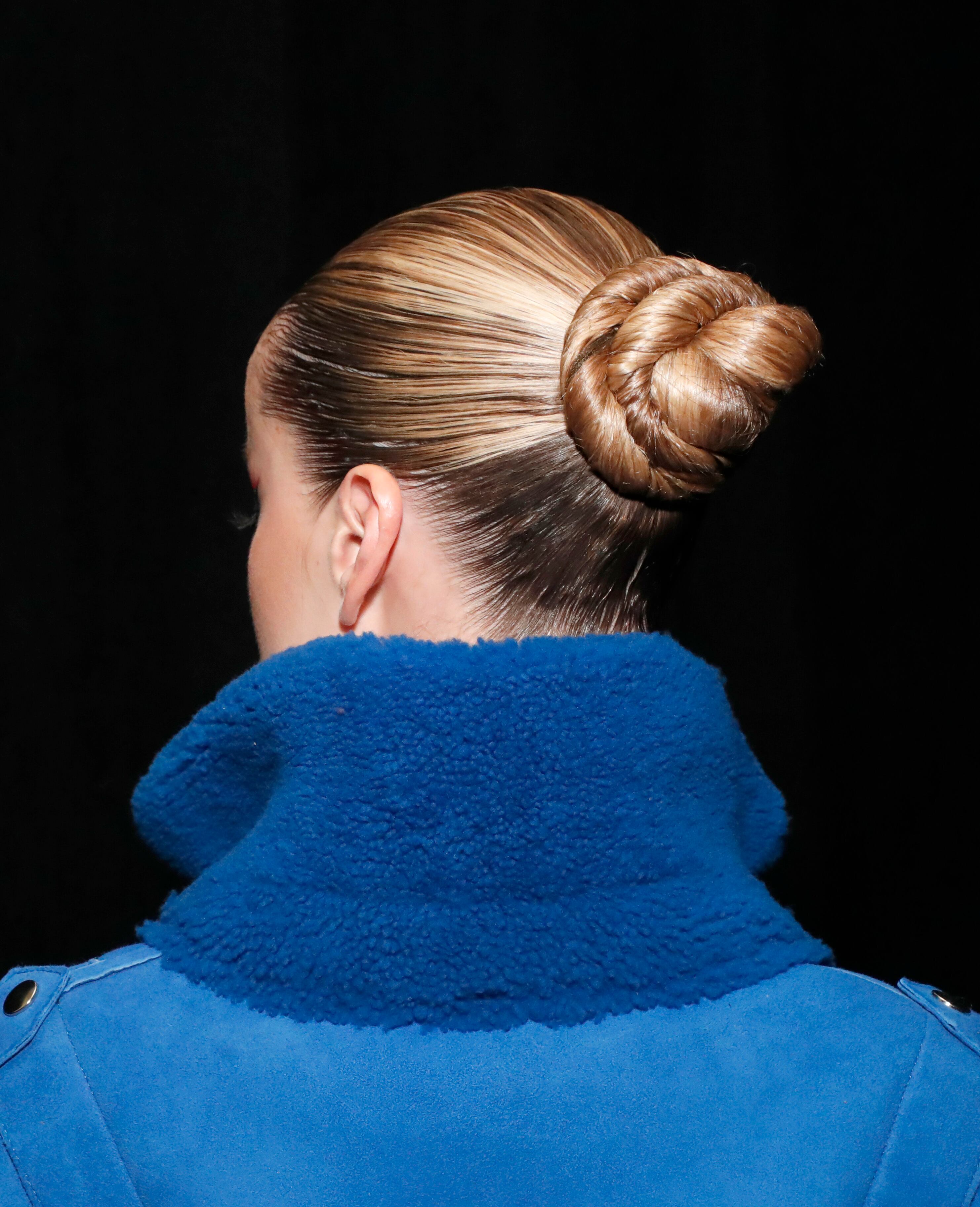 The back of model Frida Aasen's head, showing her updo details.