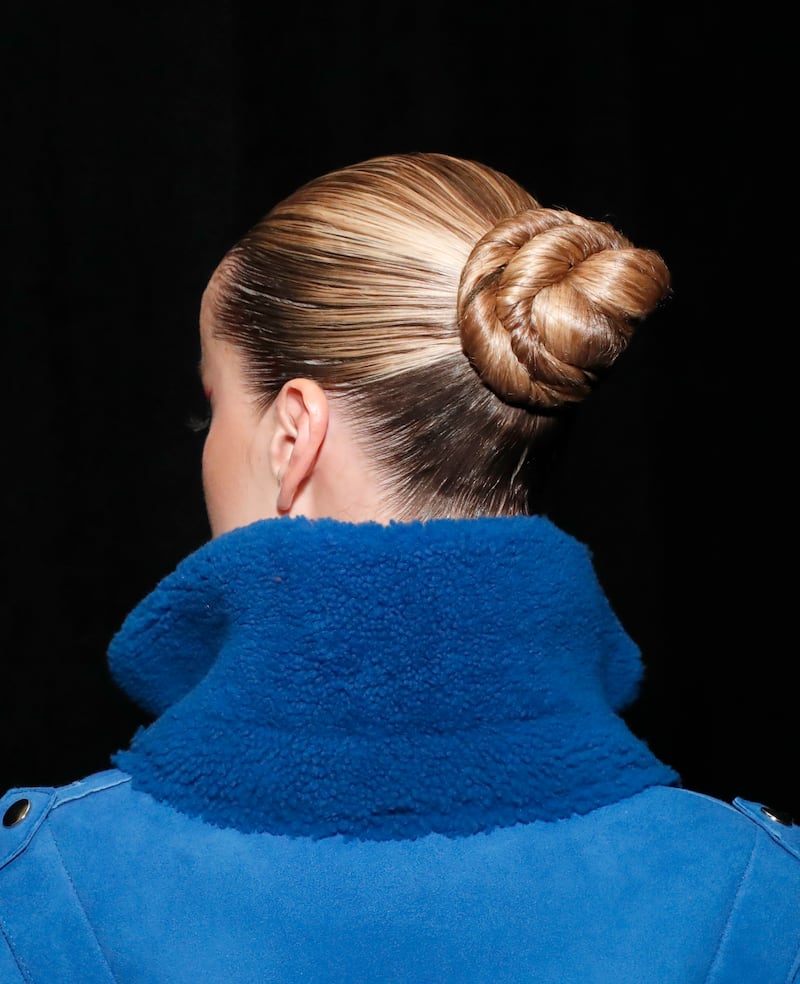 The back of model Frida Aasen's head, showing her updo details.