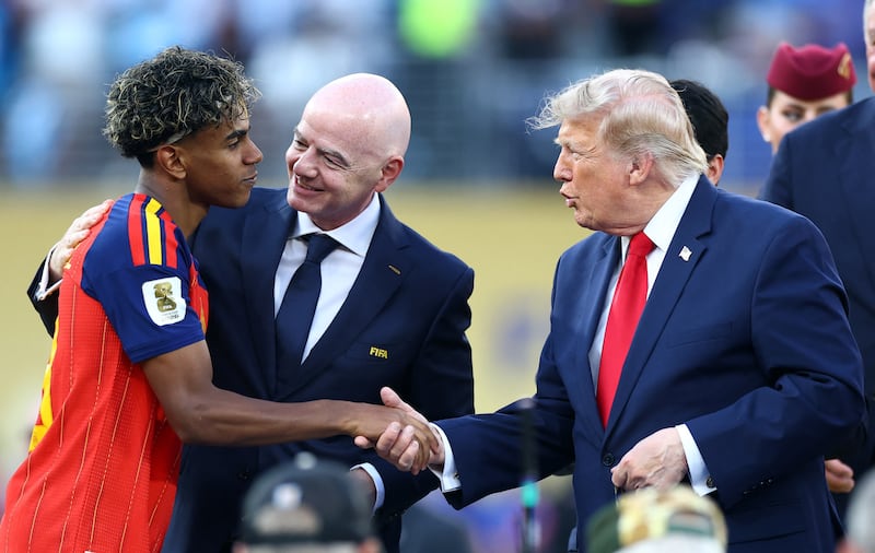Soccer Football - FIFA World Cup 2026 - Final - Spain v Argentina - New York/New Jersey Stadium, East Rutherford, New Jersey, U.S. - July 19, 2026 Spain's Lamine Yamal with FIFA president Gianni Infantino as he receives his winners medal from U.S. President Donald Trump during the trophy presentation REUTERS/Hannah Mckay