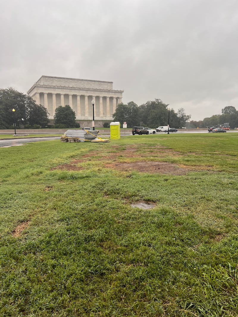 Damaged grass where a military vehicle sat for months as guards kept an eye on Trump's gilded Arts of War and Peace statues.