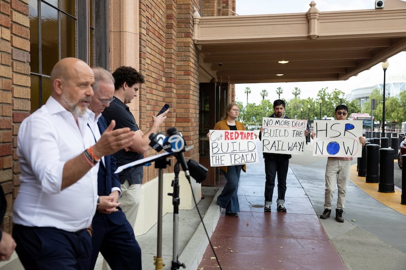 Protesters hold signs as California Republican gubernatorial candidate Steve Hilton gives a press conference outside the San Jose Diridon Station in San Jose, California, U.S., May 26, 2026.