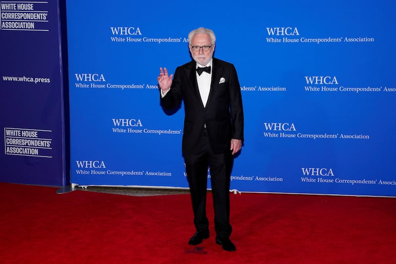 Wolf Blitzer poses on the red carpet before the event was disrupted by gunshots.