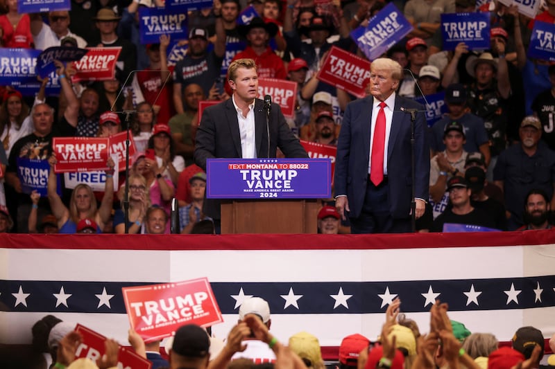 Senate candidate Tim Sheehy speaks as Republican presidential nominee and former U.S. President Donald Trump looks on at a campaign rally in Bozeman, Montana, U.S., August 9, 2024. REUTERS/Jim Urquhart