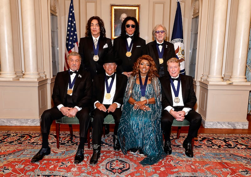 Honorees (Back Row L-R) Paul Stanley, Gene Simmons, Peter Criss of KISS and (Front Row L-R) Sylvester Stallone, George Strait, Gloria Gaynor, Michael Crawford pose for the class photo at the 48th Kennedy Center Honors Medallion Reception at the U.S. Department of State on December 06, 2025 in Washington, DC.
