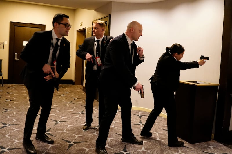 Federal agents draw their guns out after an incident at the annual White House Correspondents Association Dinner April 25, 2026 in Washington, DC. According to reports, President Donald Trump, along with other government officials, were evacuated from the Washington Hilton after what sounded like gun fire.