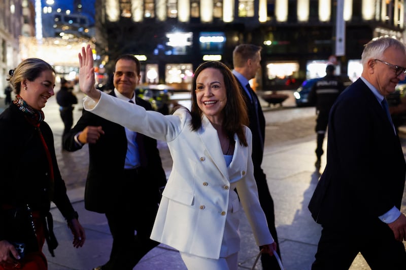 Nobel peace laureate Maria Corina Machado waves to supporters as she walks towards the Parliament for a visit in Oslo, on December 11, 2025. Machado arrived in Oslo hours after the Venezuelan opposition leader's award was collected on her behalf by her daughter. (Photo by Odd ANDERSEN / AFP via Getty Images)