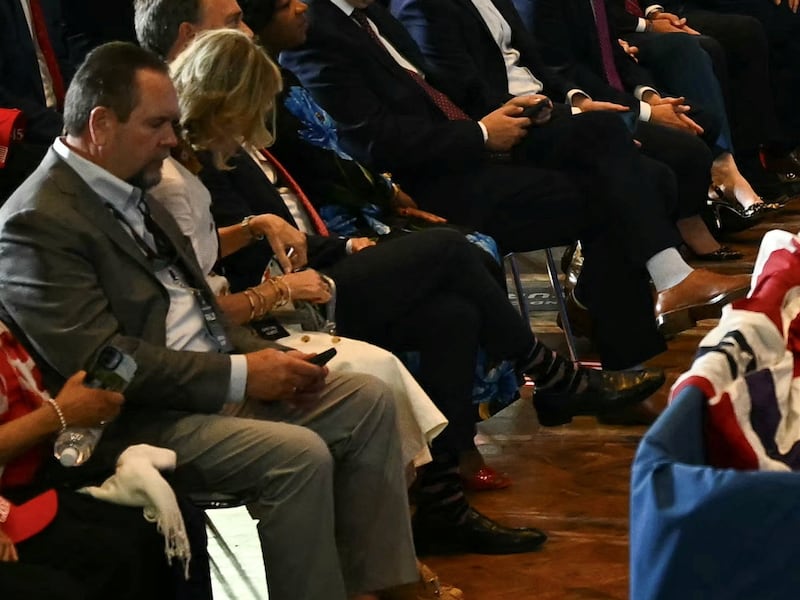 Attendees in the front row appear uninterested in Vice President Vance's speech.