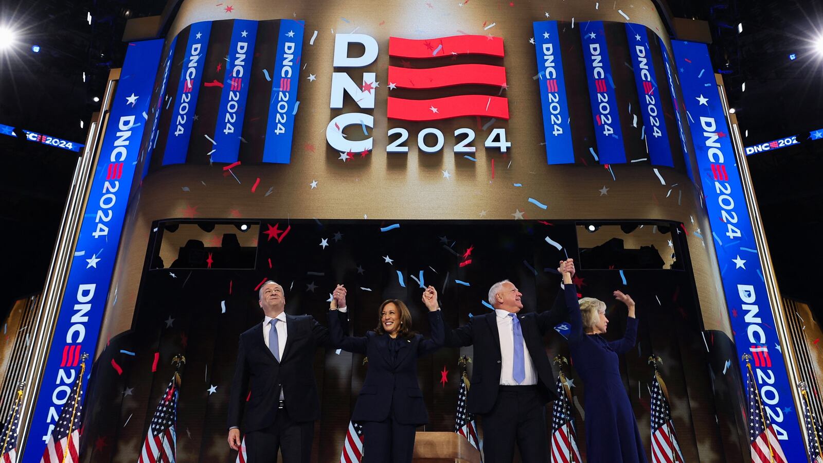 Democratic nominee Kamala Harris, her husband Doug Emhoff, Democratic vice presidential nominee Minnesota Governor Tim Walz, and his wife Gwen stand on stage on Day 4 of the Democratic National Convention.