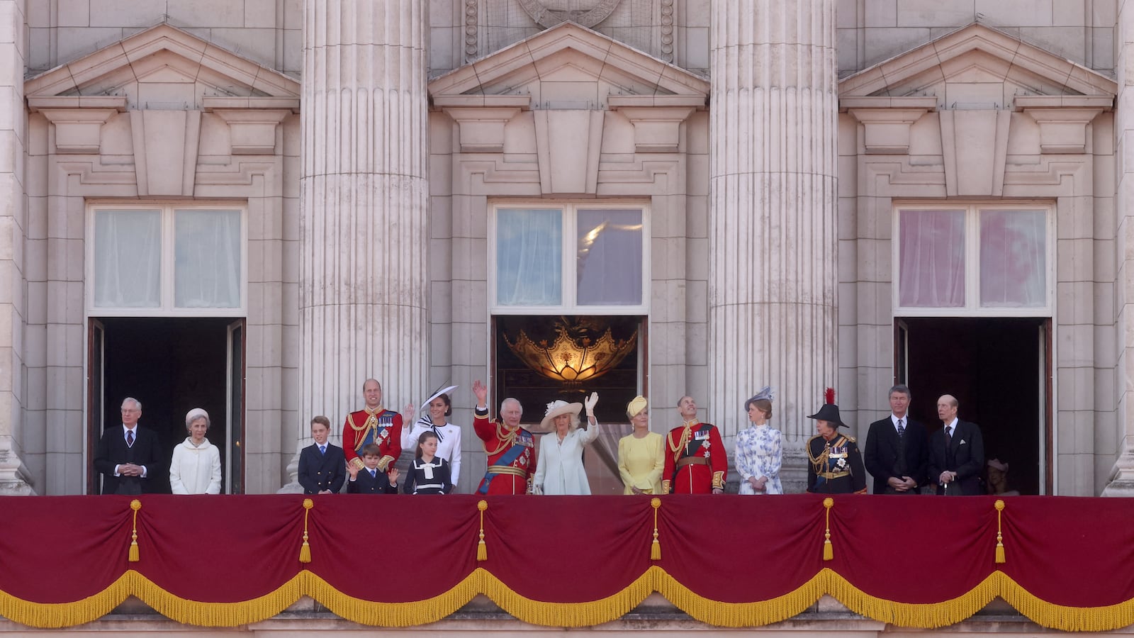 The British royal family standing on the balcony outside Buckingham Palace.
