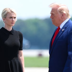 DOVER, DELAWARE - JULY 22: (L-R) U.S. Secretary of War Pete Hegseth, executive assistant to U.S. President Donald Trump Natalie Harp and U.S. President Donald Trump attend a dignified transfer at Dover Air Force Base on July 22, 2026 in Dover, Delaware. President Trump is attending the dignified transfers of Army 1st Lt. Tyler James Feehan, Army Staff Sgt. Michael Emmanuel Swinton, Army Sgt. Angel S. Rampersad and Army Pvt. Isabella Gonzales who were killed in action in Iraq and Jordan. (Photo by Kevin Dietsch/Getty Images)