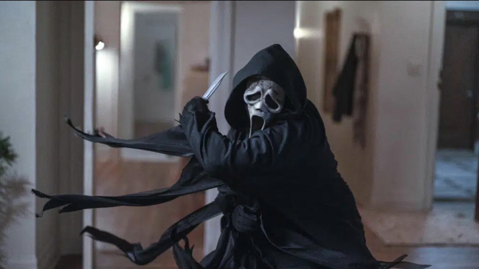 Ghostface swipes his knife as he attacks in an apartment