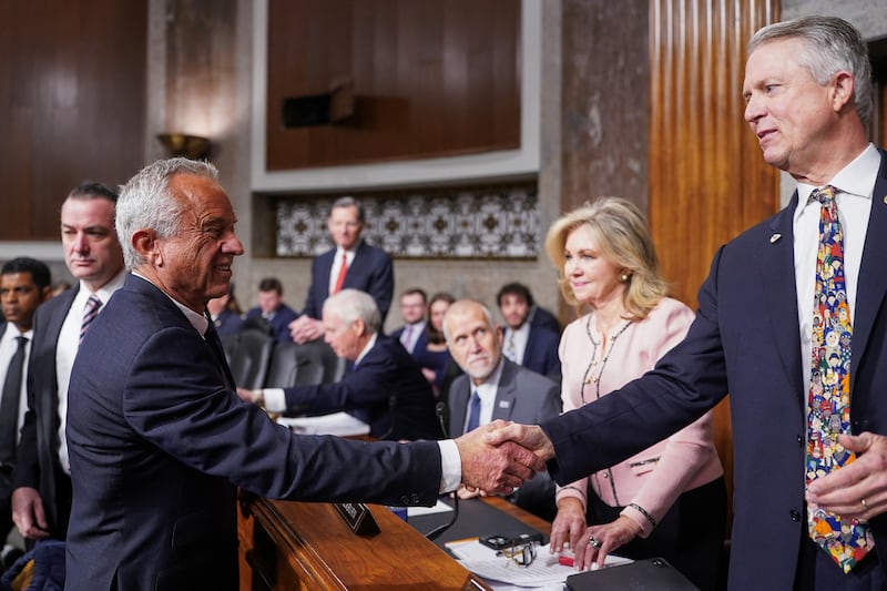 Robert F. Kennedy Jr shakes hands with U.S. Sen. Roger Marshall (R-KS), during a Senate Finance Committee confirmation hearing on Robert F. Kennedy Jr's nomination to be secretary of Health and Human Services, on Capitol Hill in Washington, U.S., January 29, 2025.
