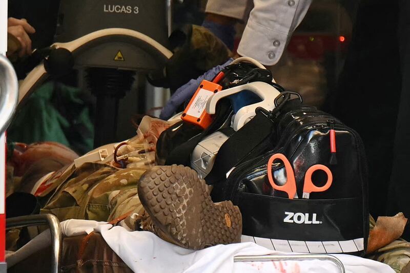 An unidentified man in military fatigues lies on a stretcher inside an ambulance 26 November, 2025 in downtown Washington, DC. Two National Guard soldiers were shot a few blocks from the White House, according to law enforcement.