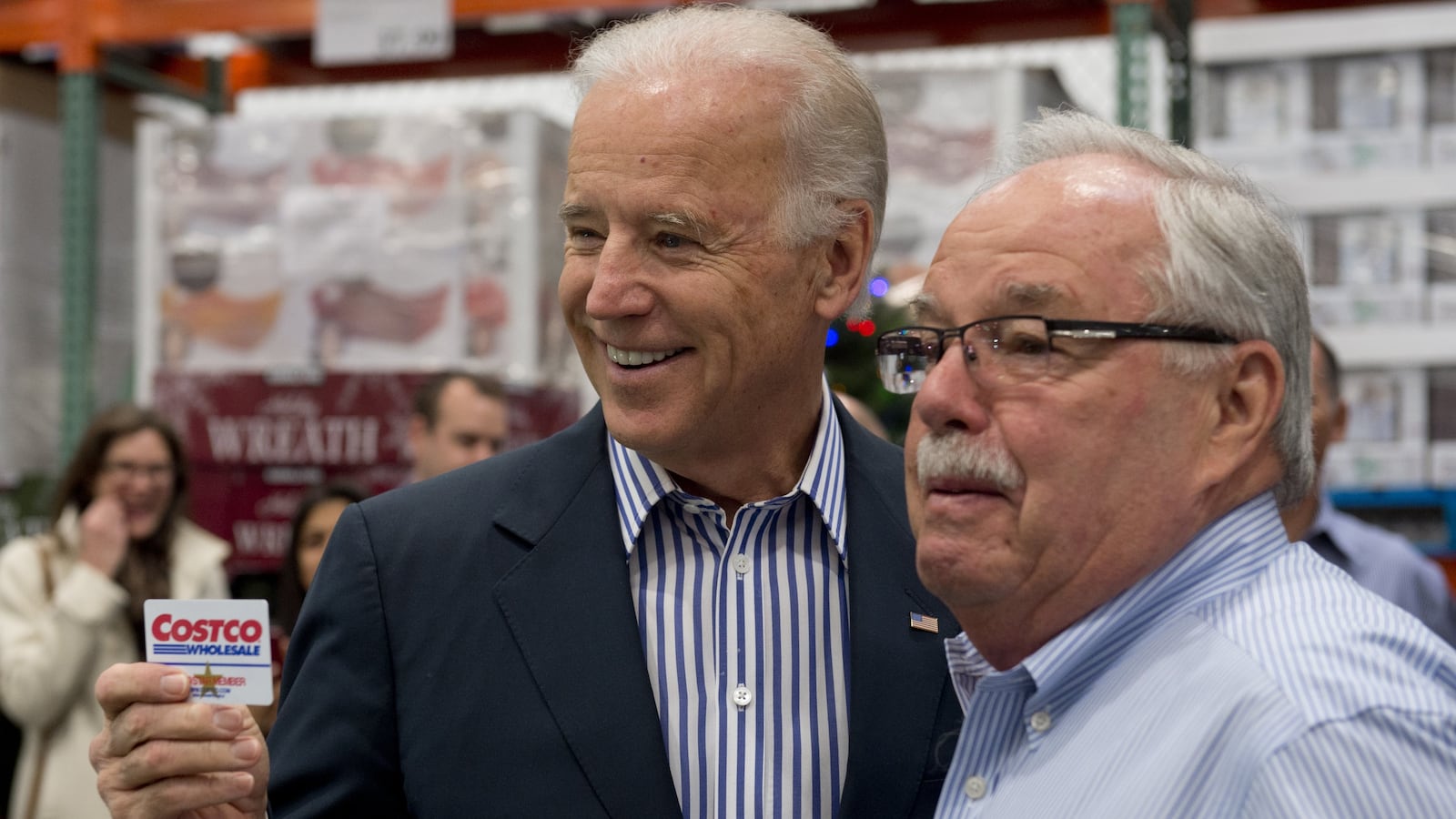 US Vice President Joe Biden holds up his Costco card alongside Costco co-founder Jim Sinegal (R) during a visit to a Costco store on a shopping trip in Washington, DC, on November 29, 2012. Biden made the visit to the first Costco store located in Washington, DC, during its grand opening. AFP PHOTO / Saul LOEB (Photo credit should read SAUL LOEB/AFP via Getty Images)