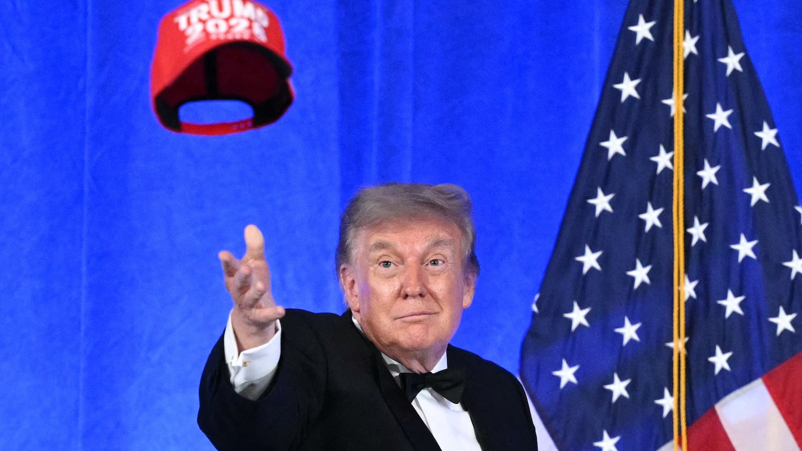 Donald Trump throws his "Trump 2028" hat into an unappreciative audience at this year's 2026 White House Correspondents' Association Dinner.