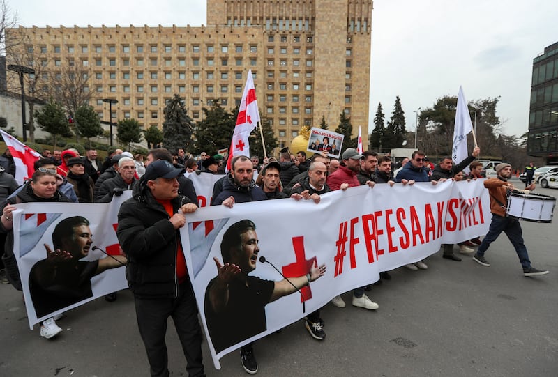 People take part in a rally to support Georgia's jailed ex-President Mikheil Saakashvili and to protest against Russia, near the government building in Tbilisi, Georgia, February 20, 2023.