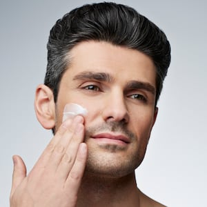 Man applying skincare