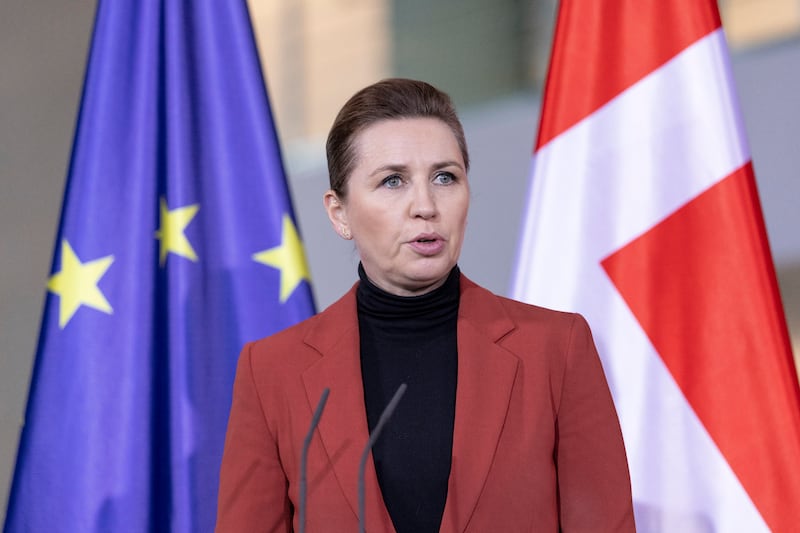 Mette Frederiksen speaks in front of the EU and Danish flags
