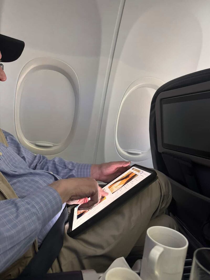 Brad Sherman scrolling X on a flight.