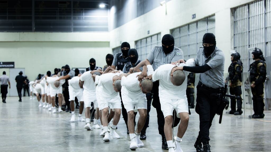 American deportees are frog-walked into a massive prison complex in El Salvador.