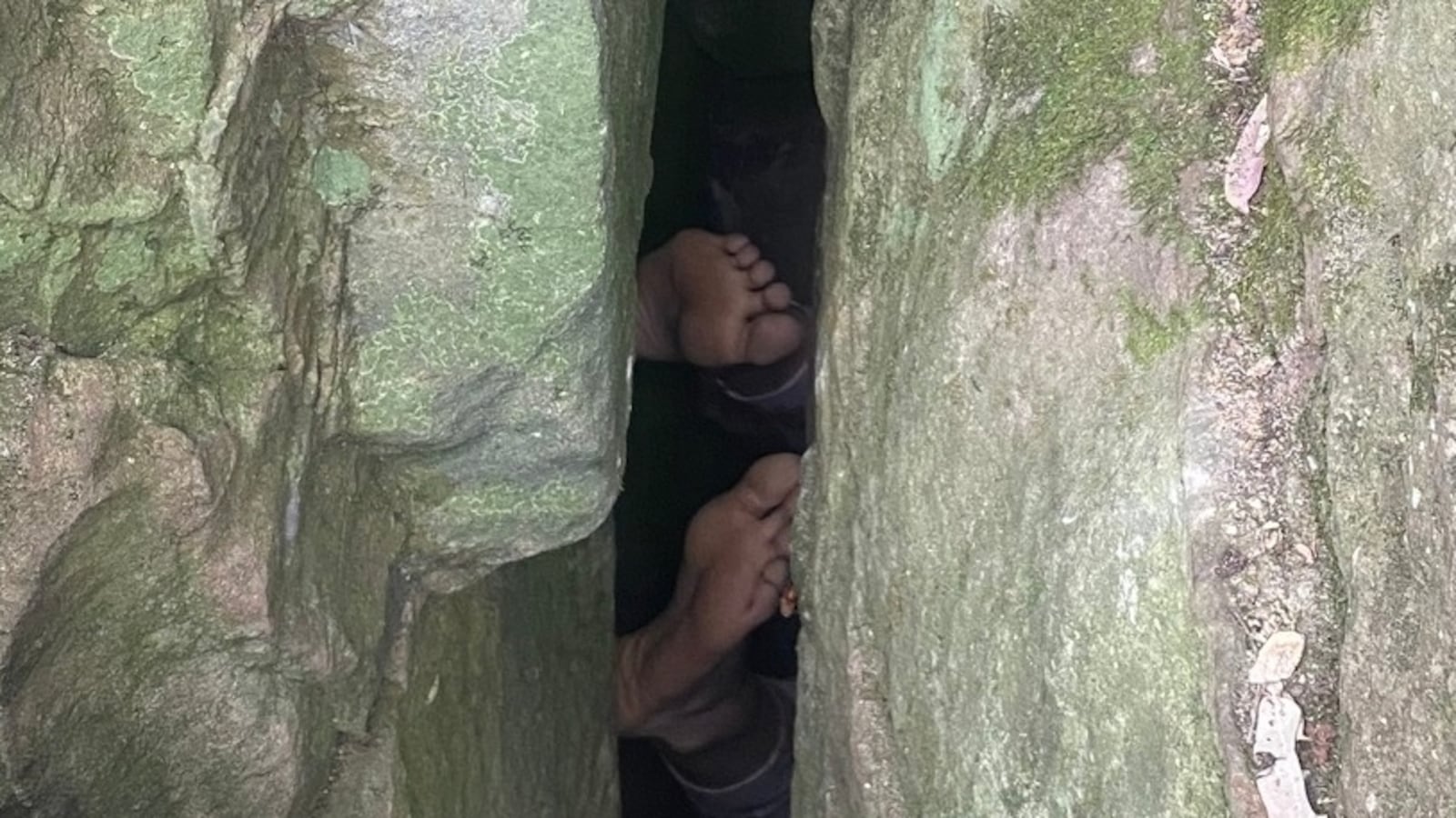 A woman trying to retrieve her phone got trapped between boulders for seven hours in Australia.