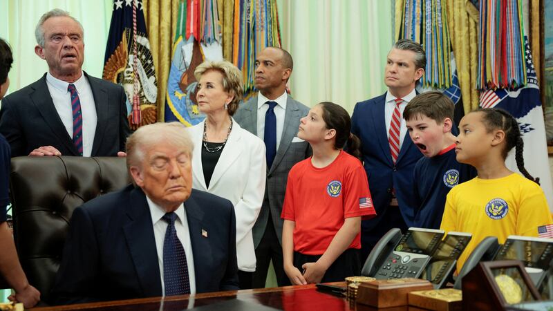Youth listens to Human Services (HHS) Secretary Robert F. Kennedy Jr speaking, next to U.S. President Donald Trump, U.S. Department of Housing and Urban Development Secretary Scott Turner,  U.S. Education Secretary Linda McMahon and U.S. Secretary of Defense Pete Hegseth during a memorandum signing event in the Oval Office at the White House in Washington, D.C., U.S., May 5, 2026. REUTERS/Evan Vucci