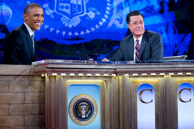 U.S. President Barack Obama, left, tapes Comedy Central's "The Colbert Report" with television personality Stephen Colbert in Lisner Auditorium at George Washington University in Washington, D.C., U.S., on Monday, Dec. 8, 2014.