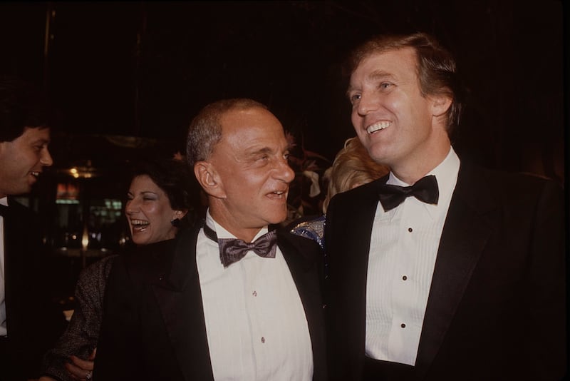 Roy Cohn (L) and Donald Trump attend the Trump Tower opening in October 1983 at The Trump Tower in New York City.