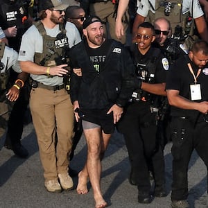 MMA fighter Sean Strickland is escorted out of the UFC Freedom 250 Fan Fest on The Ellipse by U.S. Secret Service and other law enforcement ahead of the UFC Freedom 250 fight on the South Lawn of the White House, in Washington, D.C., U.S., June 14, 2026.      Kevin Dietsch/Pool via REUTERS     TPX IMAGES OF THE DAY