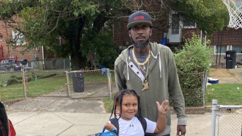 Deon Lewis with one of his kids.