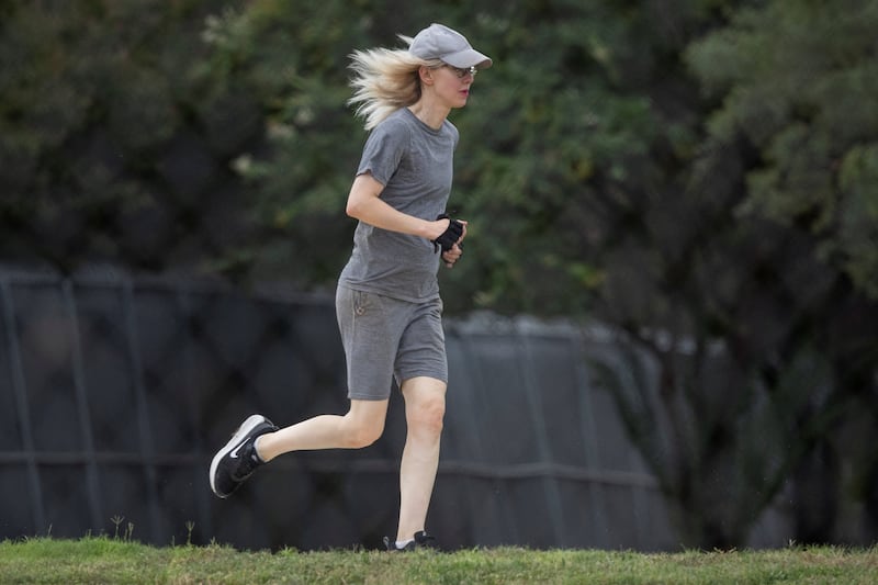 Theranos founder Elizabeth Holmes runs on the track at the Federal Prison Camp in Bryan, Texas, U.S., August 2, 2025. REUTERS/Adrees Latif