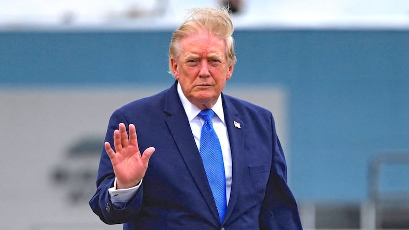 U.S. President Donald Trump waves after disembarking Marine One at Morristown Municipal Airport in Morristown, New Jersey, U.S., August 2, 2026.