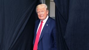 TOPSHOT - Republican presidential candidate Donald Trump comes out from behind a curtain to take the stage at an event on October 15, 2016 in Portsmouth, New Hampshire. (Photo by Mary Schwalm / AFP) (Photo by MARY SCHWALM/AFP via Getty Images)