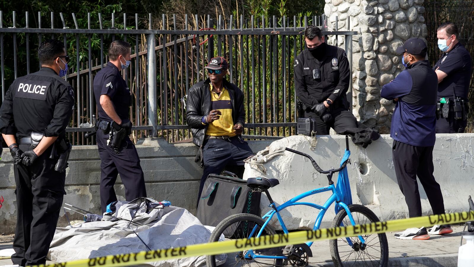 Los Angeles Police Department officers clear a homeless encampment