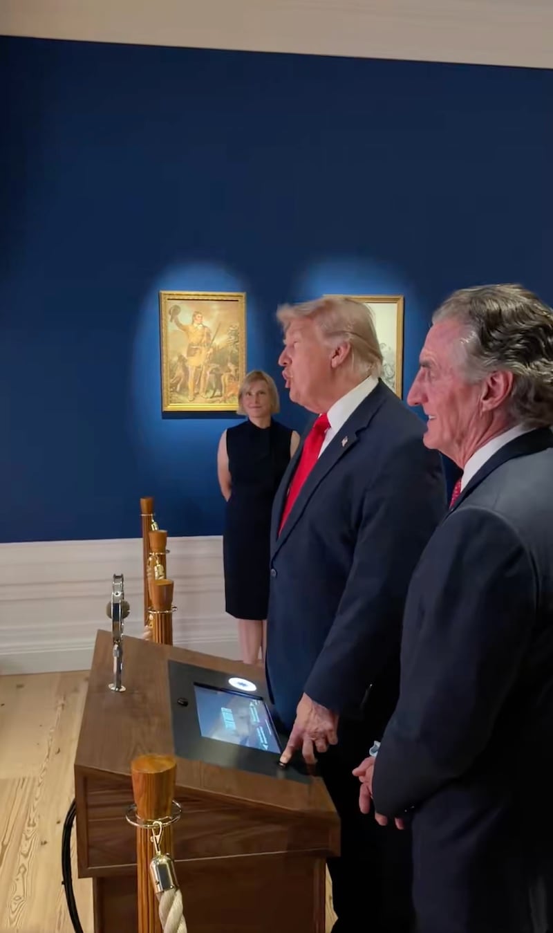 Trump speaks to the hologram of Roosevelt beside Interior Secretary Doug Burgum.