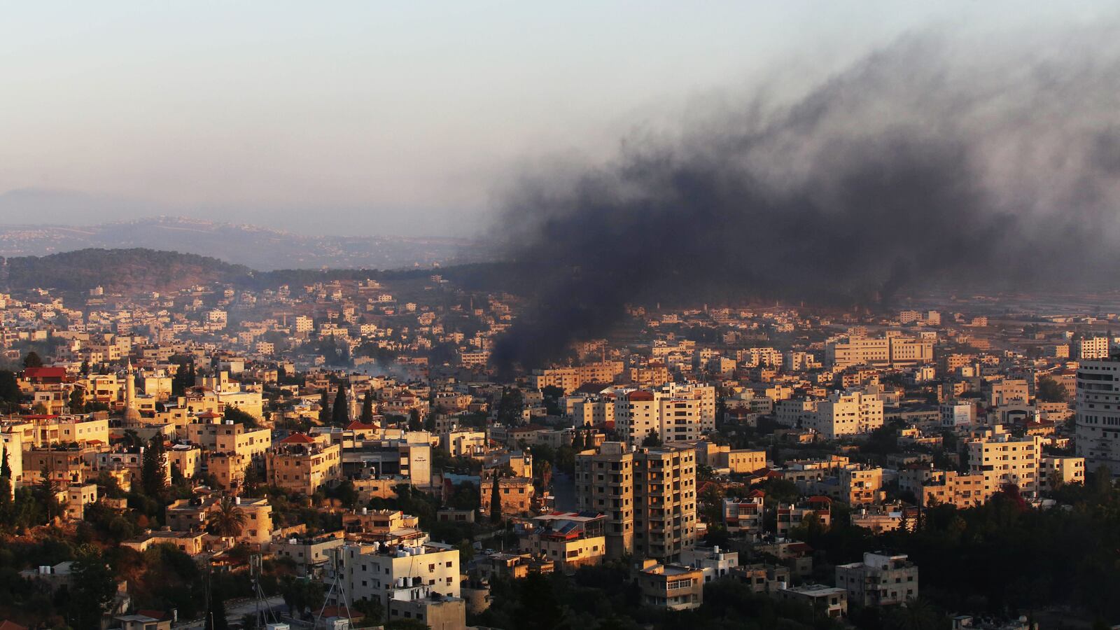 A photograph of smoking rising from buildings in Jenin, West Bank after Israeli forces conducted airstrikes and a raid on the city.