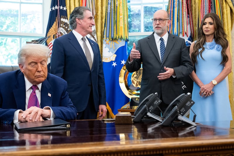 OMB Director Russell Vought (2nd R) speaks alongside President Donald Trump (L), Secretary of the Interior Doug Burgum (2nd L), and Secretary of Homeland Security Kristi Noem (R) in the Oval Office of the White House in Washington, DC, in June 2025.