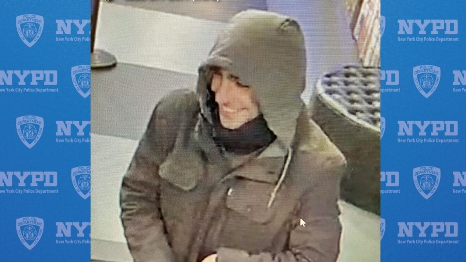 A man in a brown jacket smiling.